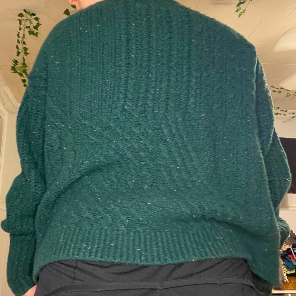 green sweater with hints of rainbow colors!